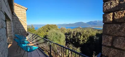 a balcony with a view of the water and mountains at Maison de Charme Vue Exceptionnelle Mer & Montagne in Campomoro
