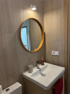 a bathroom with a white sink and a mirror at Cherry & Mountain Appartement in Ajaccio