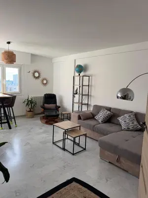 a living room with a couch and a table at Cherry & Mountain Appartement in Ajaccio
