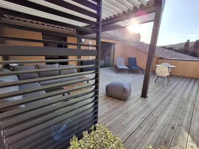 a wooden deck with a fence on a house at T2 cozy terrasse 40 m2 et pergola in Pianottoli-Caldarello