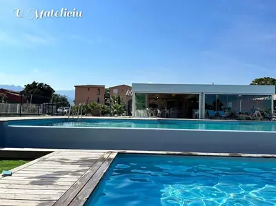 a swimming pool in front of a house at logement piscine Porto Vecchio U Mateliciu in Lecci
