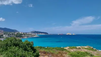 a view of the ocean from a hill at La maison du bonheur in Ville-di-Paraso