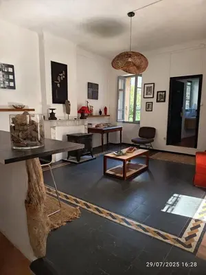 a living room with a table and a living room with at La maison du bonheur in Ville-di-Paraso