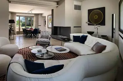 a living room with a white couch and a table at Sea and mountain in Prunelli-di-Fiumorbo