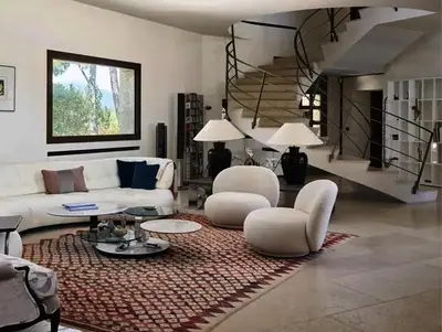 a living room with white furniture and a staircase at Sea and mountain in Prunelli-di-Fiumorbo