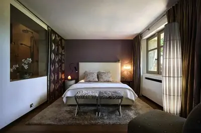 a bedroom with a large bed and a large window at Sea and mountain in Prunelli-di-Fiumorbo