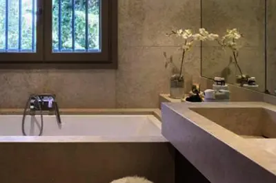 a bathroom with a tub and a sink with a mirror at Sea and mountain in Prunelli-di-Fiumorbo