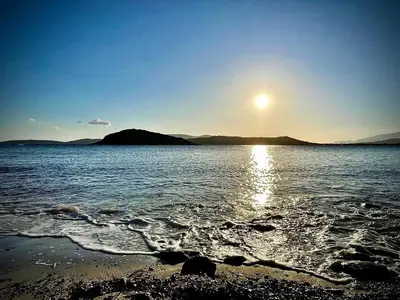 a sun setting over a large body of water at Villa proche Saint Cyprien et Cala Rossa in Lecci