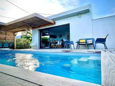 a swimming pool in front of a house at Villa proche Saint Cyprien et Cala Rossa in Lecci