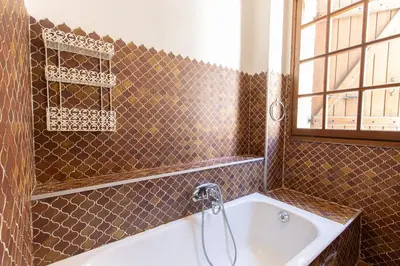 a bathroom with a bath tub and a sink at L'OMU DI CAGNA in Sartène