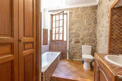 a bathroom with a tub and a toilet and a sink at L'OMU DI CAGNA in Sartène