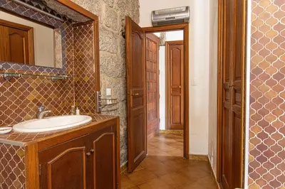 a bathroom with a sink and a mirror at L'OMU DI CAGNA in Sartène
