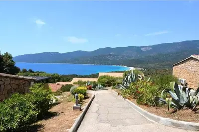 a pathway with a view of a body of water at Grand F2 clim wifi lave linge vue mer résidence piscine mer à pied in Serra-di-Ferro