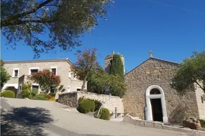 a large stone building with a door on a street at Grand F2 clim wifi lave linge vue mer résidence piscine mer à pied in Serra-di-Ferro