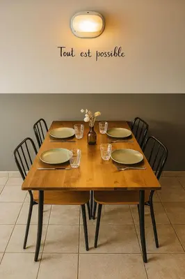a wooden table with chairs and plates and flowers on it at Appartement 225 in Serra-di-Ferro