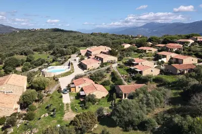 an aerial view of a villa with a pool and a house at Magnifique T2 terrasse vue mer panoramique dans résidence avec piscine in Serra-di-Ferro