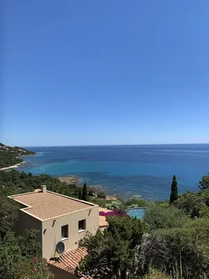 a white house with a view of the ocean at Villa 10 personnes avec piscine vue mer in Conca