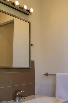 a bathroom with a sink with a mirror and a mirror at Villa 10 personnes avec piscine vue mer in Conca
