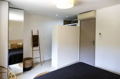 a room with a closet and a bed and a mirror at Villa 10 personnes avec piscine vue mer in Conca
