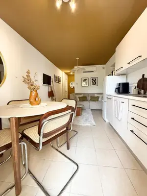 a kitchen and dining room with a table and chairs at Appartement 2 CHAMBRES PISCINE TERRASSE SAINT FLORENT in Oletta
