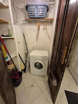 a laundry room with a washing machine and a washer at rez de villa confort & grand extérieur in Furiani