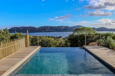 a swimming pool with a view of the water at Villa Marina Di Porto-Vecchio in Porto-Vecchio