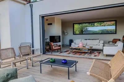 a living room with a couch and a table at Villa Marina Di Porto-Vecchio in Porto-Vecchio
