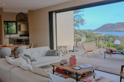 a living room with a large sliding glass door at Villa Marina Di Porto-Vecchio in Porto-Vecchio
