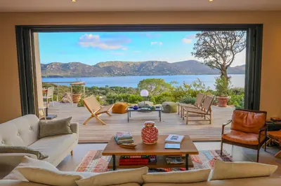 a living room with a view of a large window at Villa Marina Di Porto-Vecchio in Porto-Vecchio