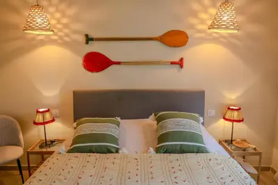 a bedroom with a bed with a baseball bat on the wall at Villa Marina Di Porto-Vecchio in Porto-Vecchio