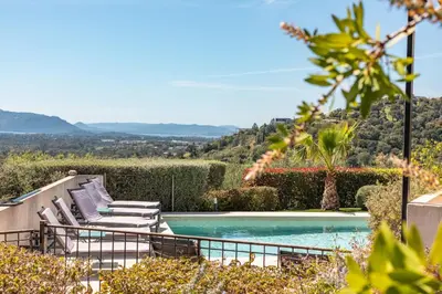 a swimming pool with two lounge chairs next to a pool at Villa Dolce Di Cirendinu in Sainte-Lucie de Porto-Vecchio
