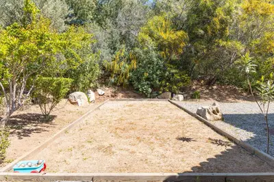 a sandbox in the middle of a garden at Villa Dolce Di Cirendinu in Sainte-Lucie de Porto-Vecchio
