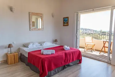 a bedroom with a bed with a red blanket at Villa Dolce Di Cirendinu in Sainte-Lucie de Porto-Vecchio