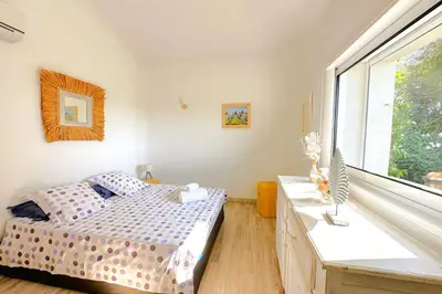 a bedroom with a bed and a large window at Villa Dolce Di Cirendinu in Sainte-Lucie de Porto-Vecchio
