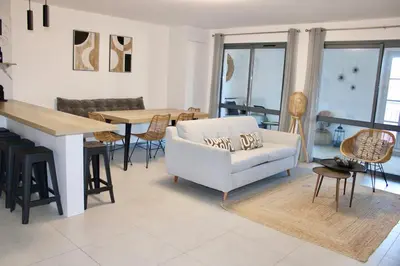 a living room with a white couch and a table at Superbe Appartement port de Bonifacio in Bonifacio