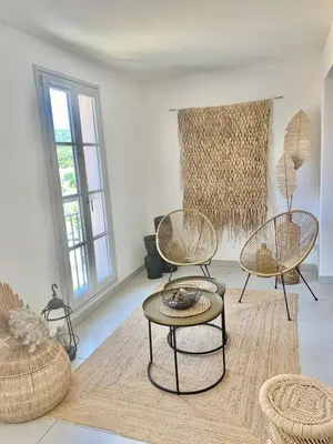 a living room with three chairs and a table at Superbe Appartement port de Bonifacio in Bonifacio