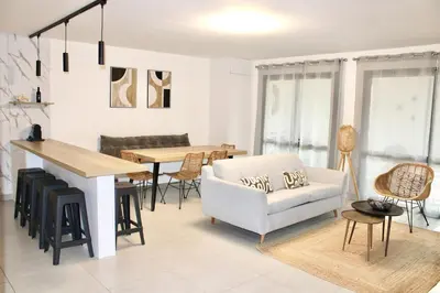 a living room with a couch and a table at Superbe Appartement port de Bonifacio in Bonifacio