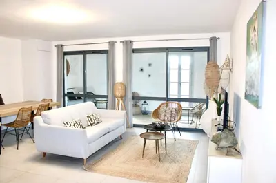 a living room with a white couch and a table at Superbe Appartement port de Bonifacio in Bonifacio