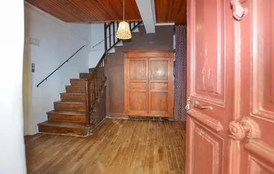 a hallway with a staircase and a wooden door at 3 Bedroom Awesome Apartment In Olmeto in Olmeto