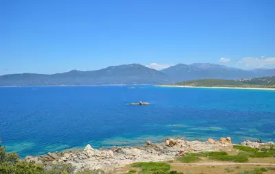 a large body of water with mountains in the background at 3 Bedroom Awesome Apartment In Olmeto in Olmeto
