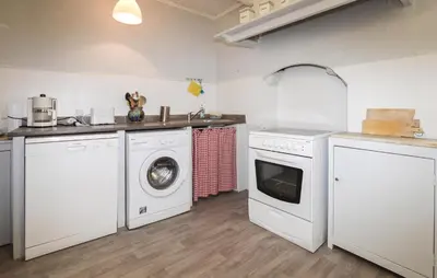 a kitchen with washing machines and a sink at 3 Bedroom Awesome Apartment In Olmeto in Olmeto