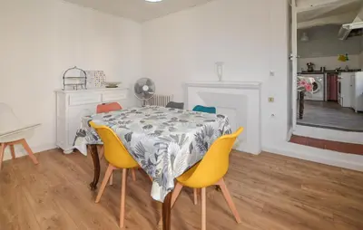 a dining room with a table and yellow chairs at 3 Bedroom Awesome Apartment In Olmeto in Olmeto