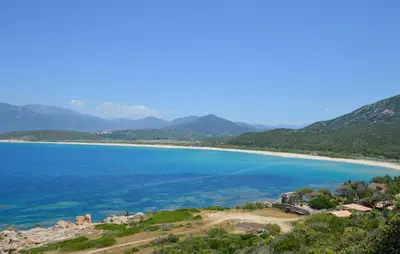 a view of a beach with mountains in the background at 3 Bedroom Awesome Apartment In Olmeto in Olmeto