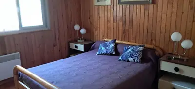 a bedroom with a bed with two blue pillows at Casa di l Ulivu in Porto Pollo