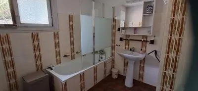 a bathroom with a sink and a bath tub and a sink at Casa di l Ulivu in Porto Pollo