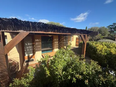 a building with a thatched roof with bushes at Mini-villa 4 personnes - Soléa 82 - vue nature in Serra-di-Ferro