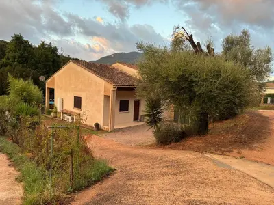 a house on the side of a dirt road at villa paisible à la campagne in Alata