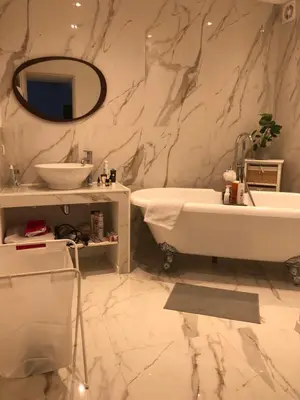 a bathroom with a white tub and a sink at villa paisible à la campagne in Alata