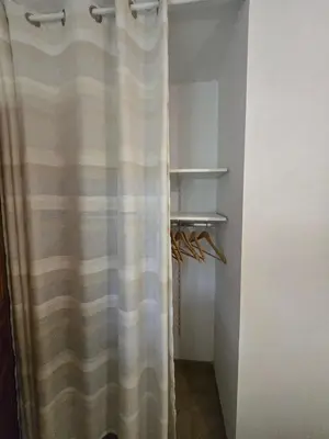 a bathroom with a shower curtain in a room at Mini villa vue jardin dans résidence calme wifi piscine mer à pied in Serra-di-Ferro