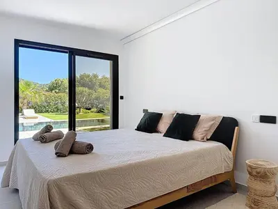 a bedroom with a large bed with a large window at Casa Jean Baptiste in Lecci